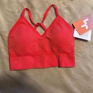 JL sports bra with a V-neck and criss-cross straps in the back.
